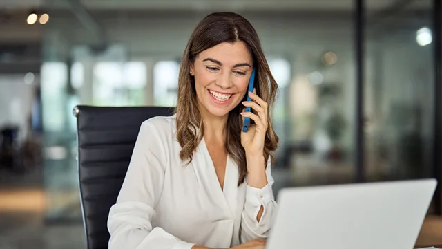 sales-crm-strategy woman on the phone while using the laptop